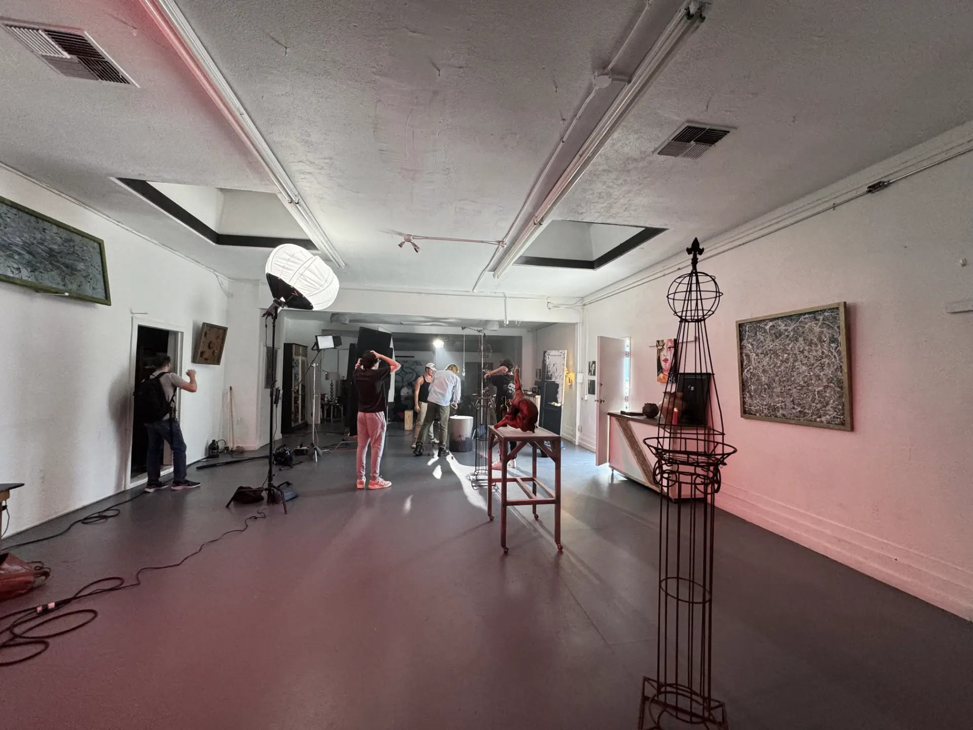 Creative crew setting up professional lighting in a photography studio Baldwin Hills for a premium art gallery event.