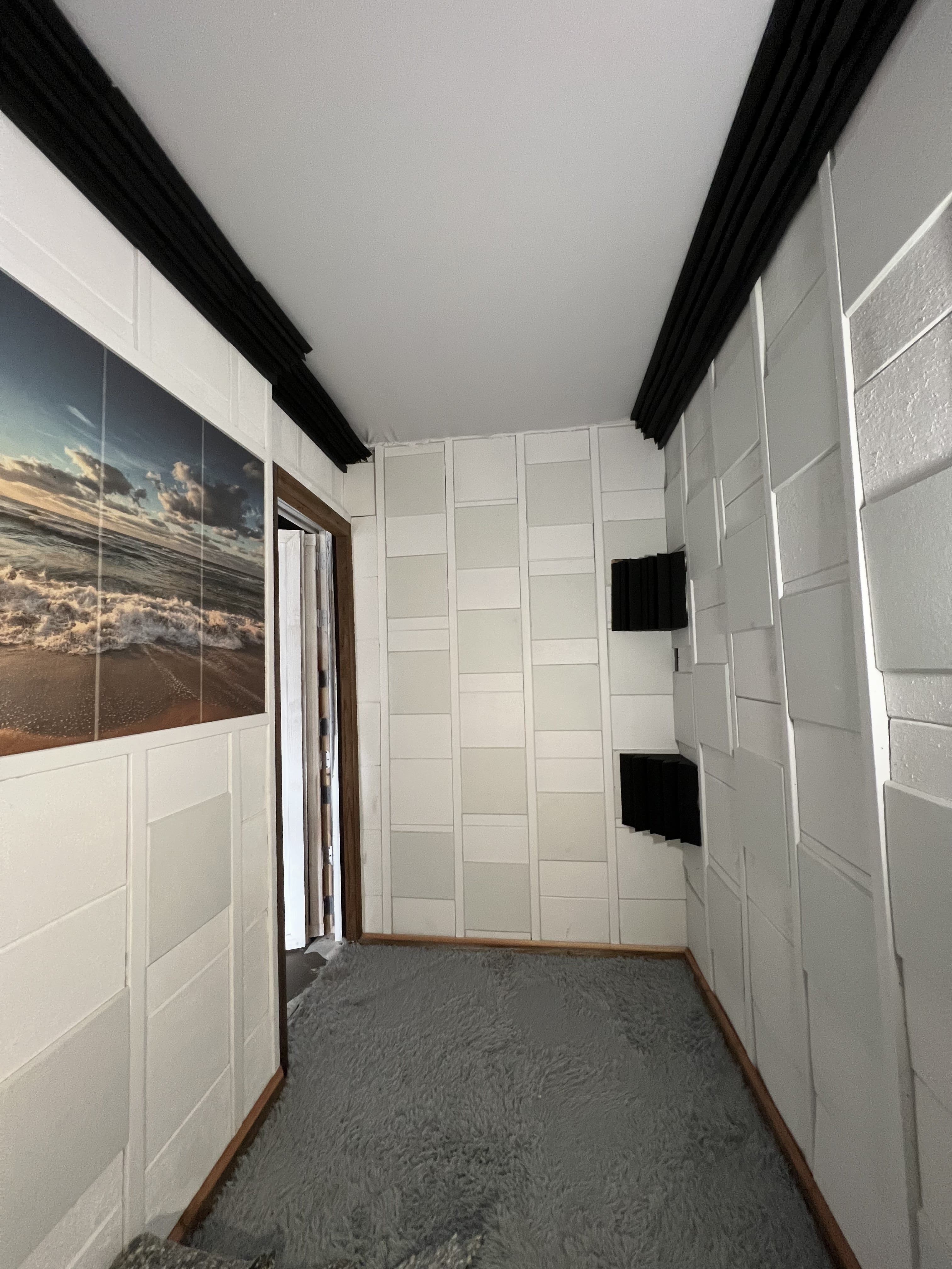Acoustically treated recording booth interior with soundproof foam panels at podcast studio in Mid-City Los Angeles.
