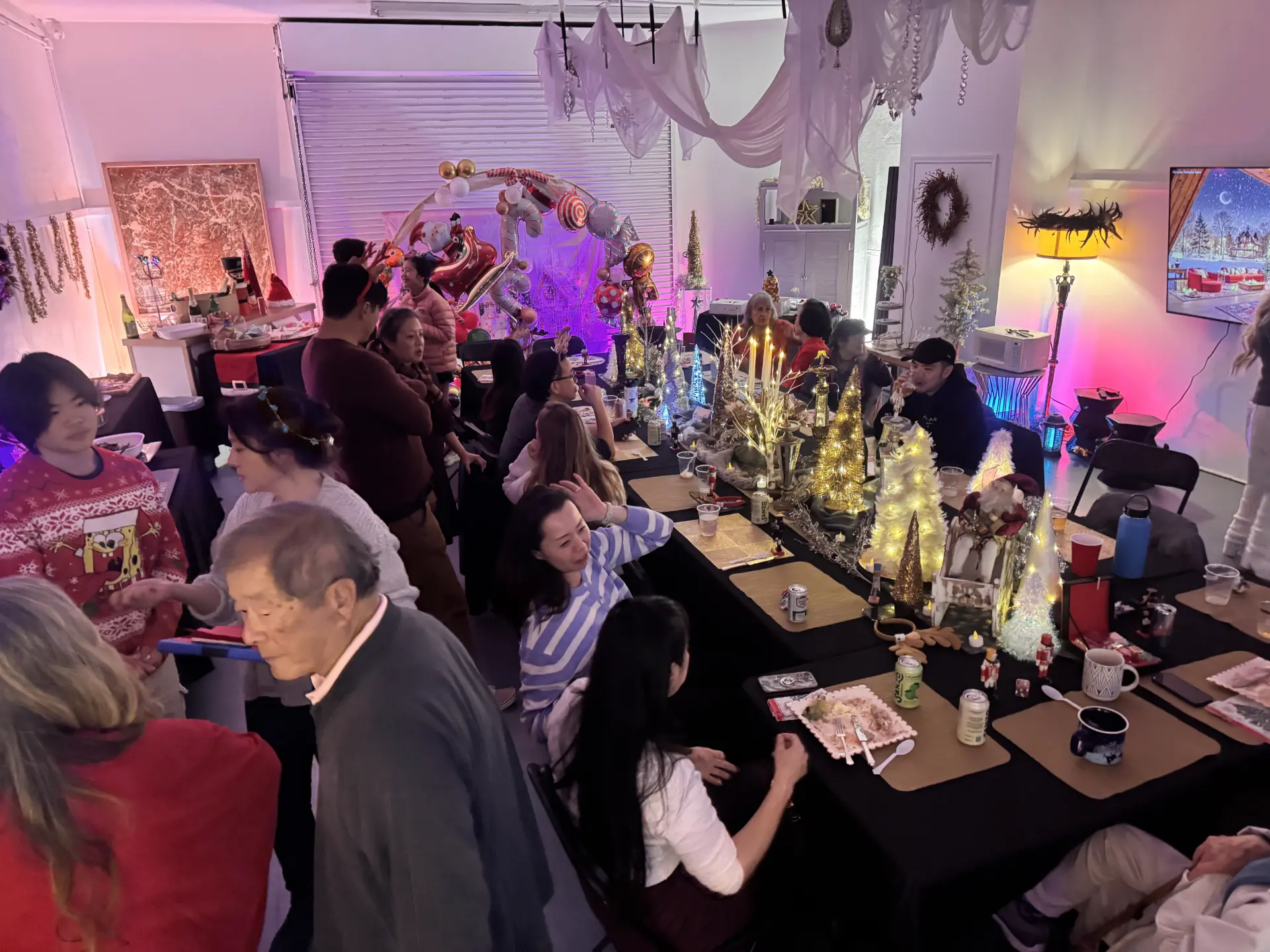 Guests celebrating at a decorated holiday party at Art and Space LA in Mid-City Los Angeles