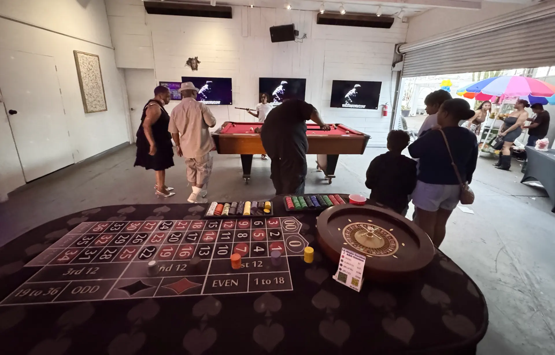 Guests playing at a wooden roulette wheel during a premium milestone birthday party in Rancho Park.