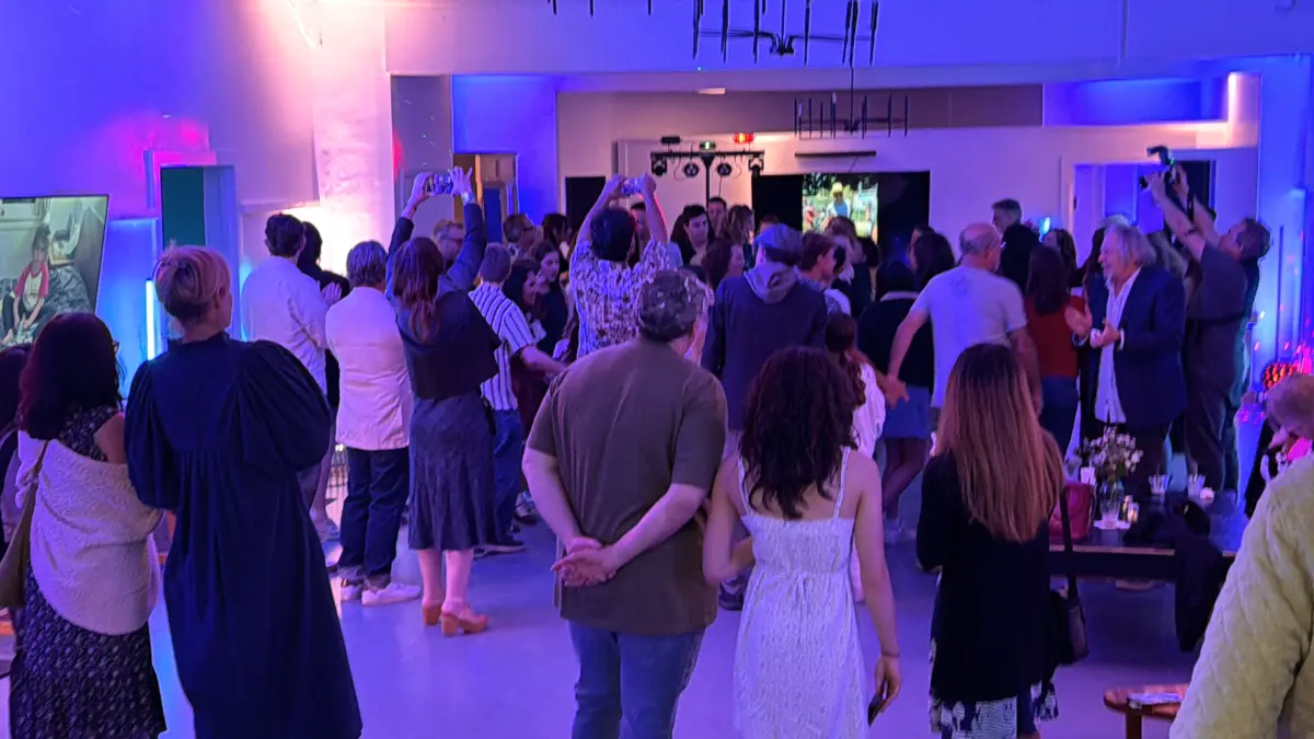 Guests celebrating at a premium Bat Mitzvah venue in West Hollywood featuring modern purple lighting and immersive digital art displays.