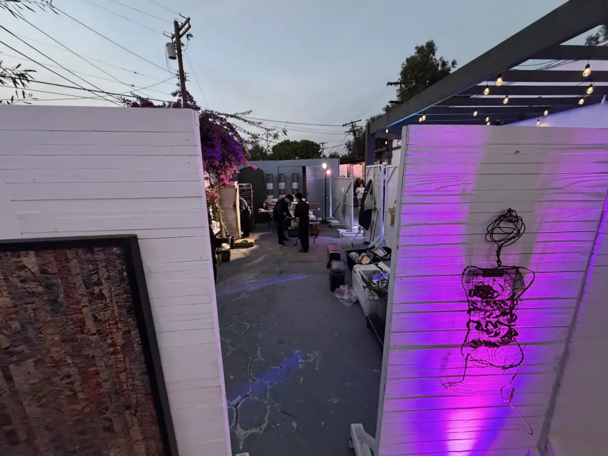 Staff preparing an industrial outdoor event space for a premium Bat Mitzvah venue in Culver City featuring vibrant purple lighting and modern decor.